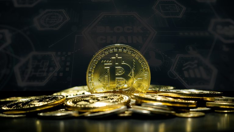 Golden bitcoin coins displayed with cryptocurrency symbols in the background